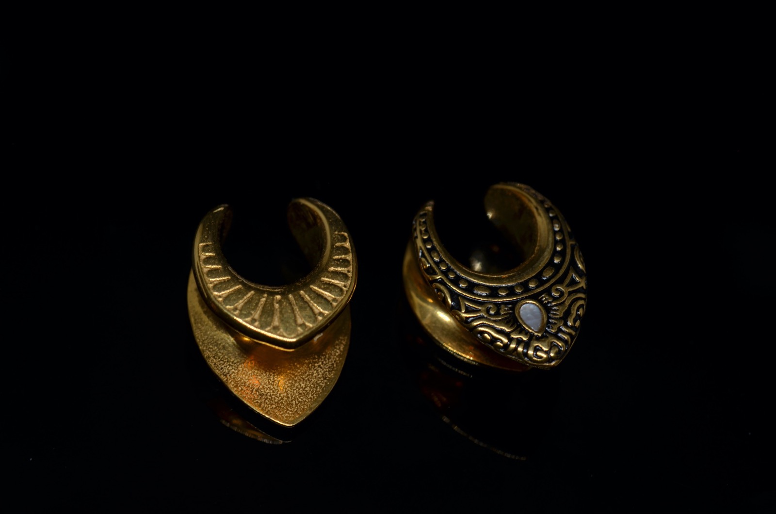 Wenu Mapu — brass ear weights, hand-cast, macro detail