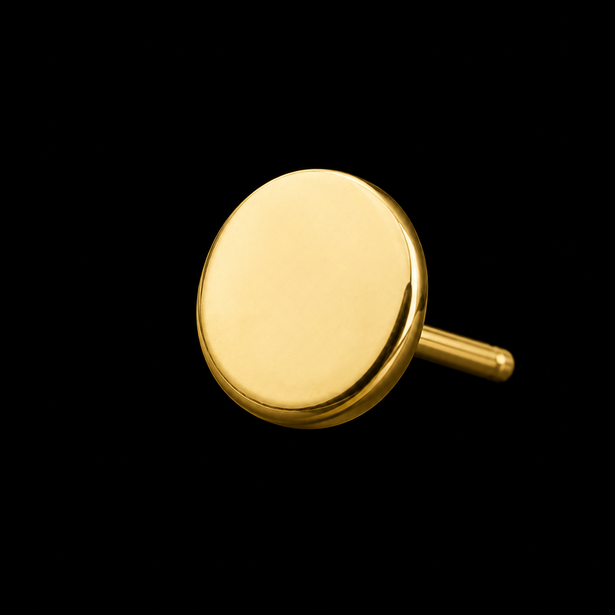 A plain polished gold disc on a threadless post, photographed on black.