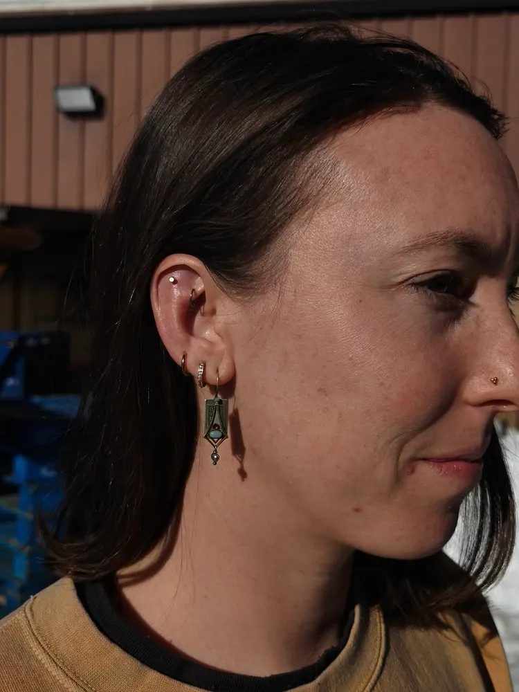 Curated ear with hanging adornment, healed